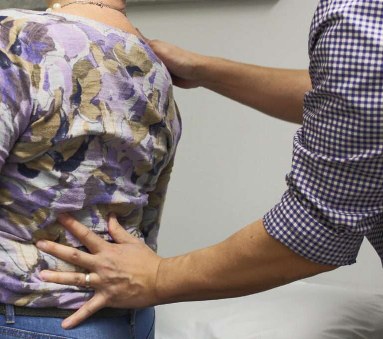 Chiropractor providing manual therapy to patient