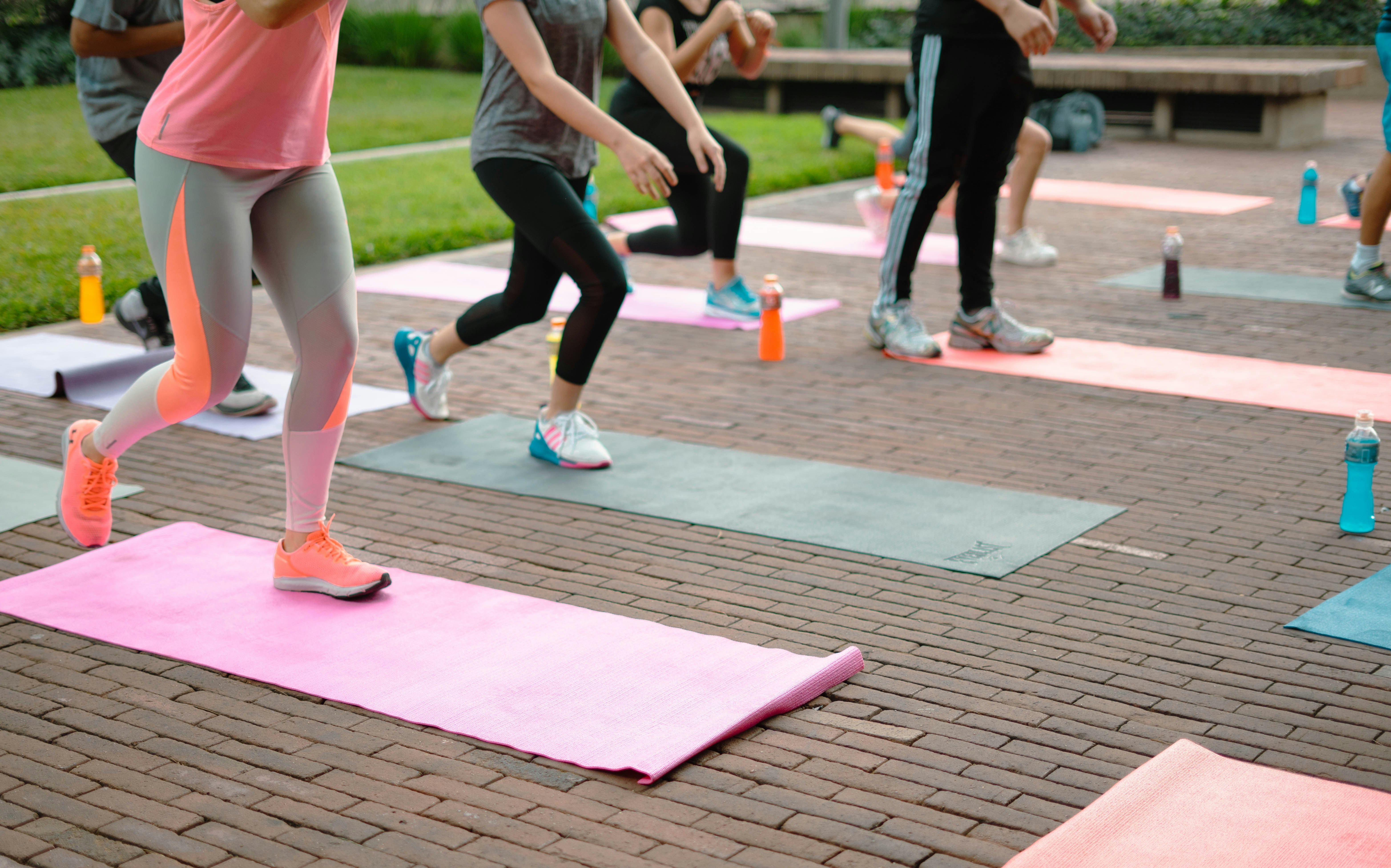 Group of people on Yoga mat doing exercise