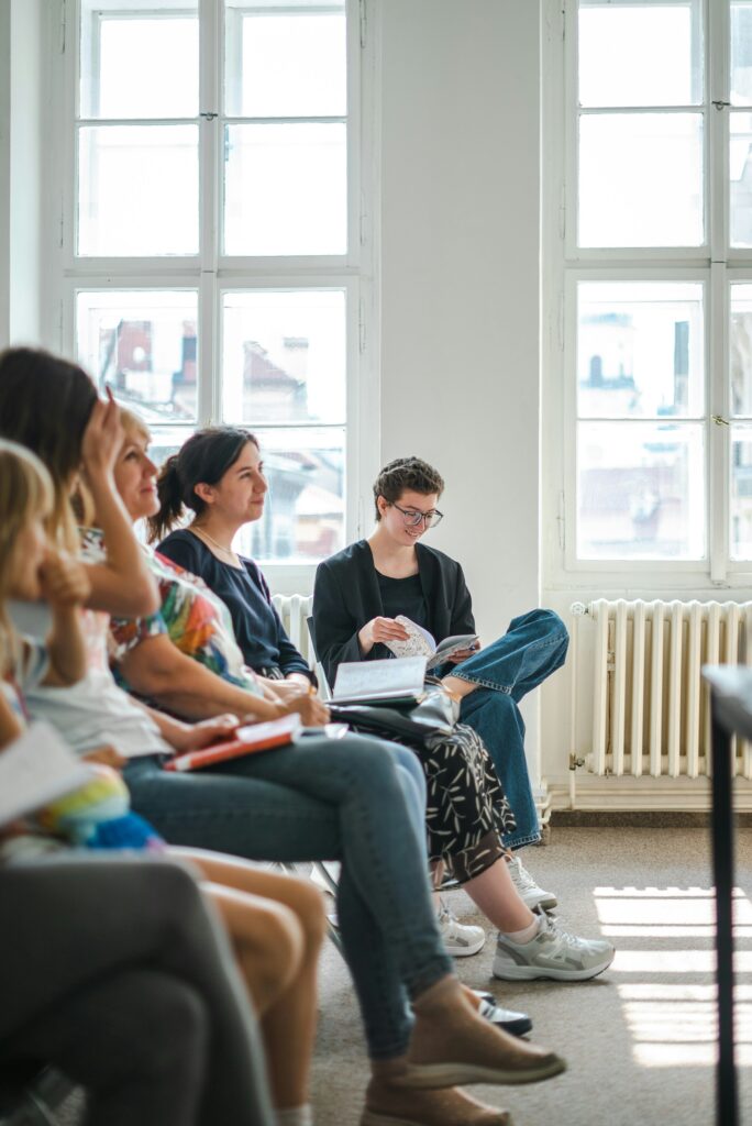 Group of people sitting and listening